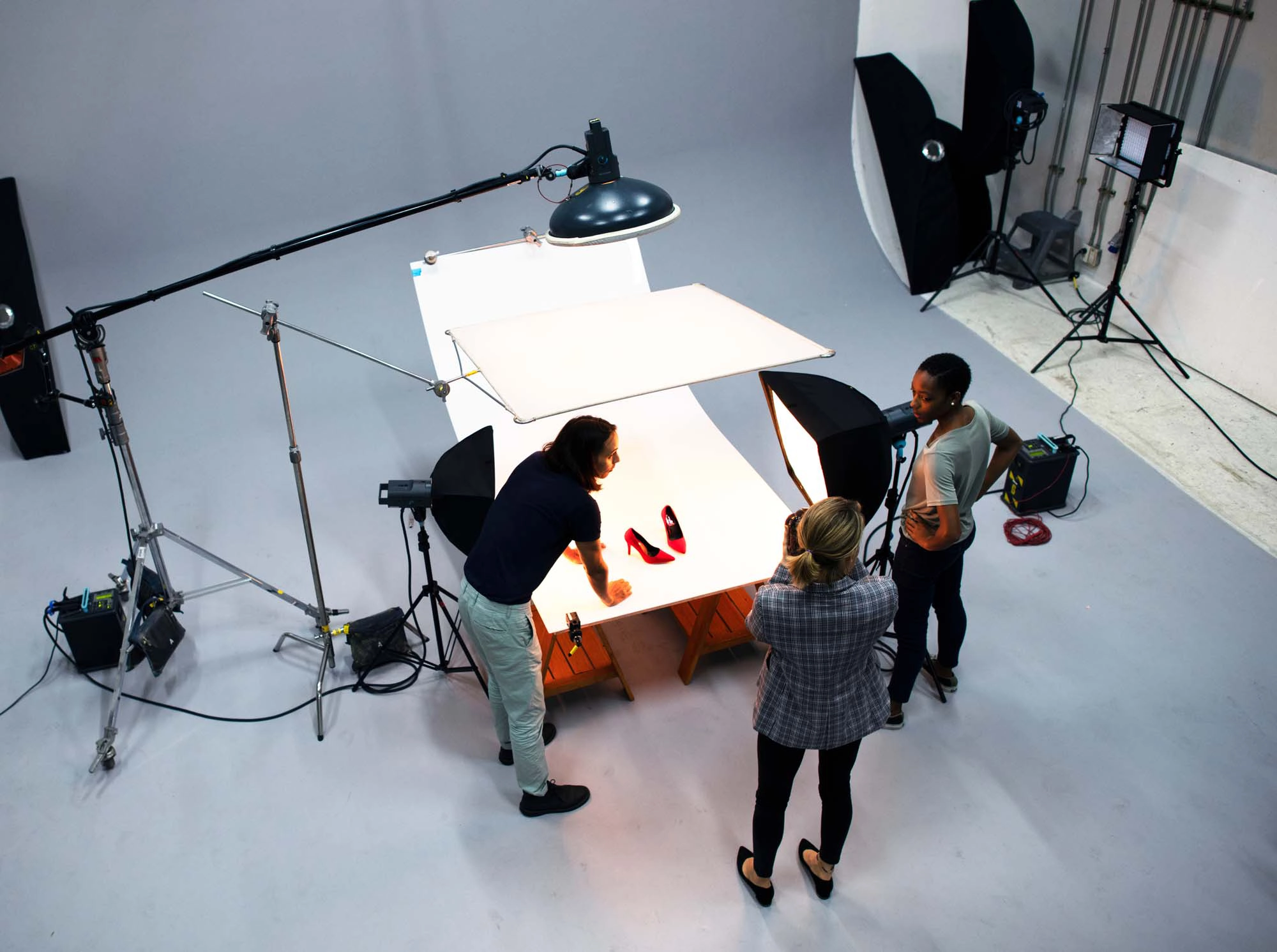 High-quality images of three people with a camera, showcasing products for ecommerce listings, websites, and social media platforms.